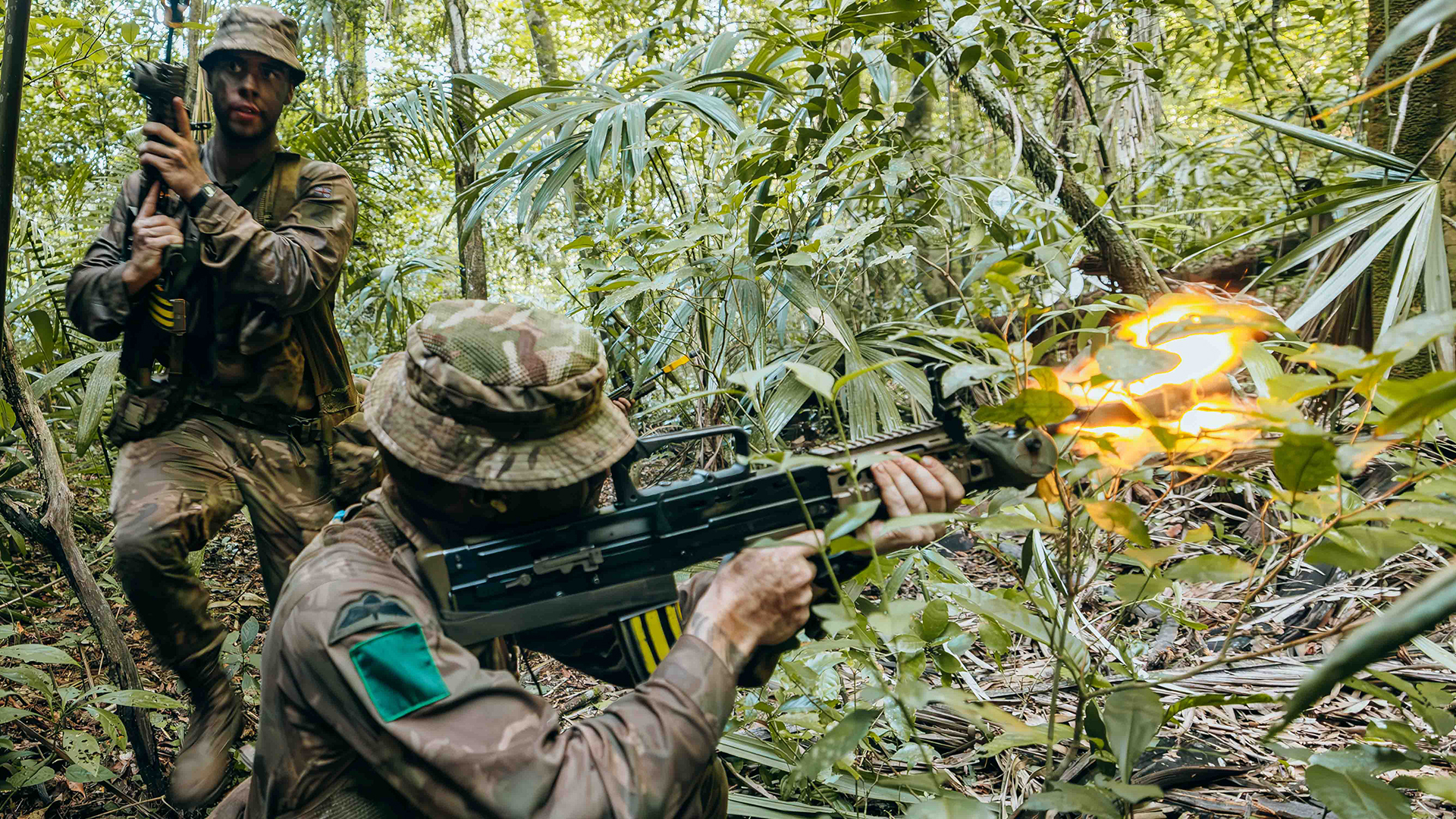 A para opens fire with blank ammo from his SA80 L85 A2, but operating in the jungle is about surviving just as much as engaging the enemy