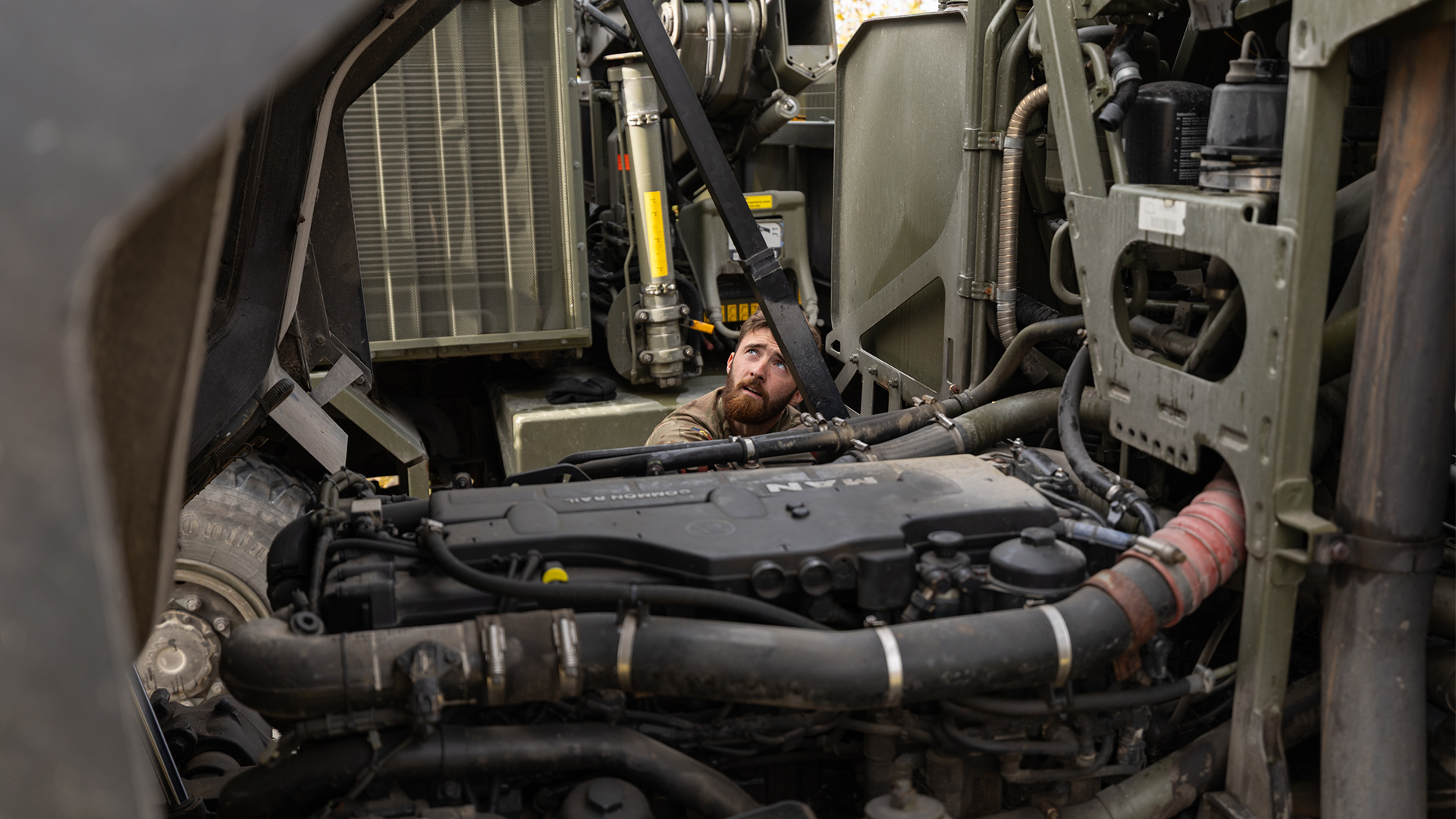 A REME soldier works on a MAN Support Vehicle