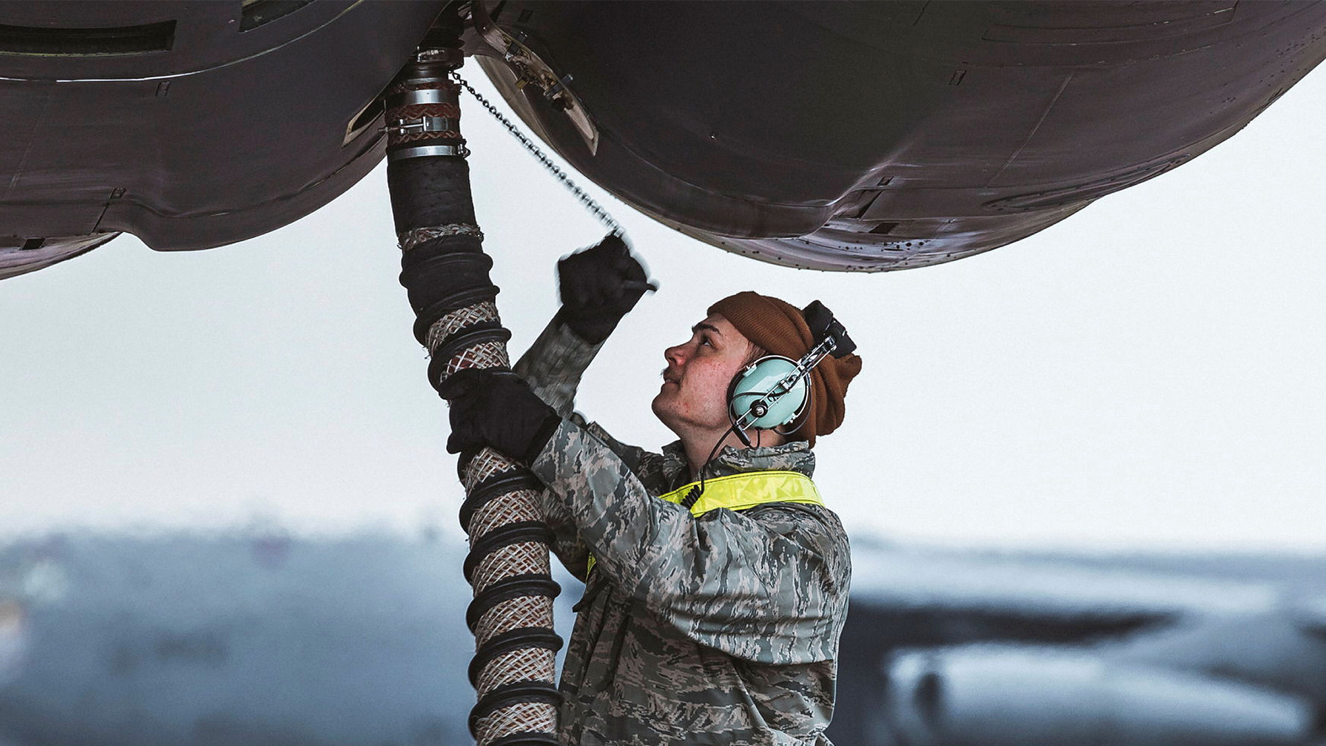 A US Air Force ground technician hooks up a fuel line to a B-52H at RAF Fairford - the bomber is powered by eight turbojet engines