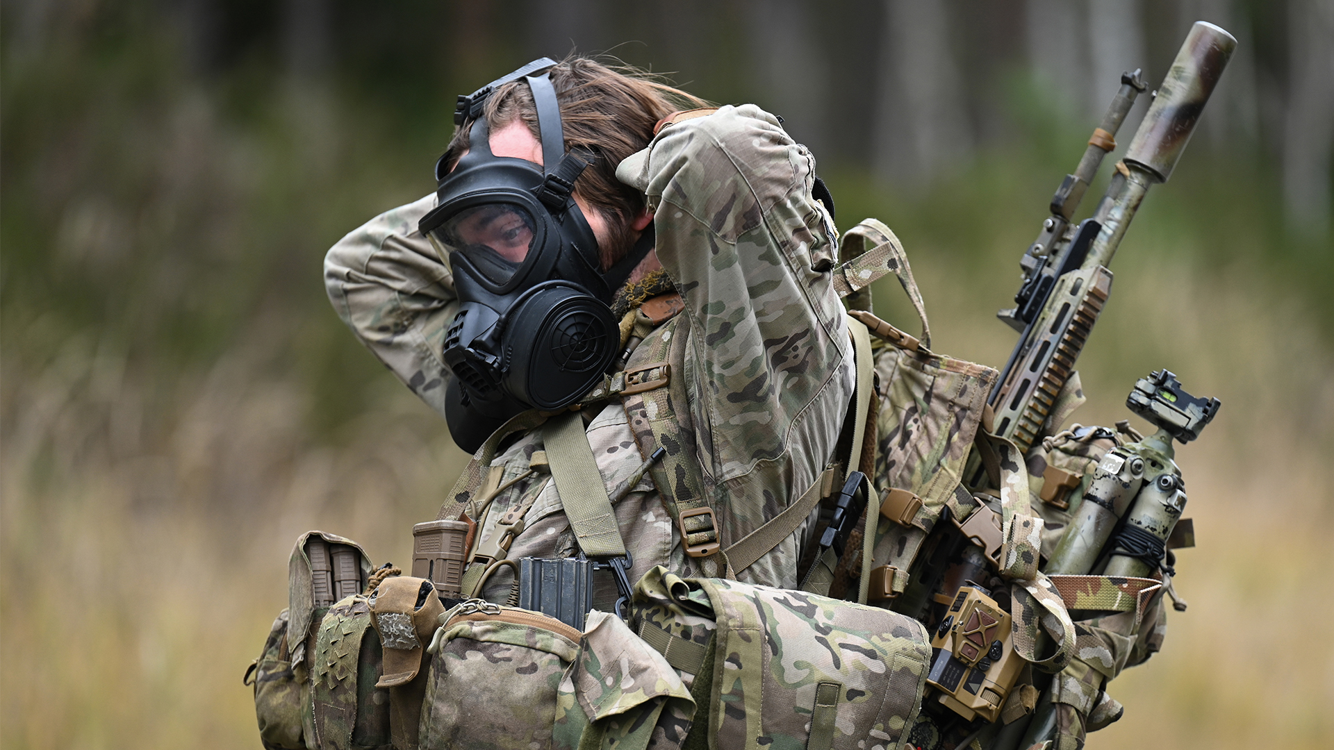 A Danish sniper dons his gas mask during the European Best Sniper Team Competition in Grafenwoehr, Germany