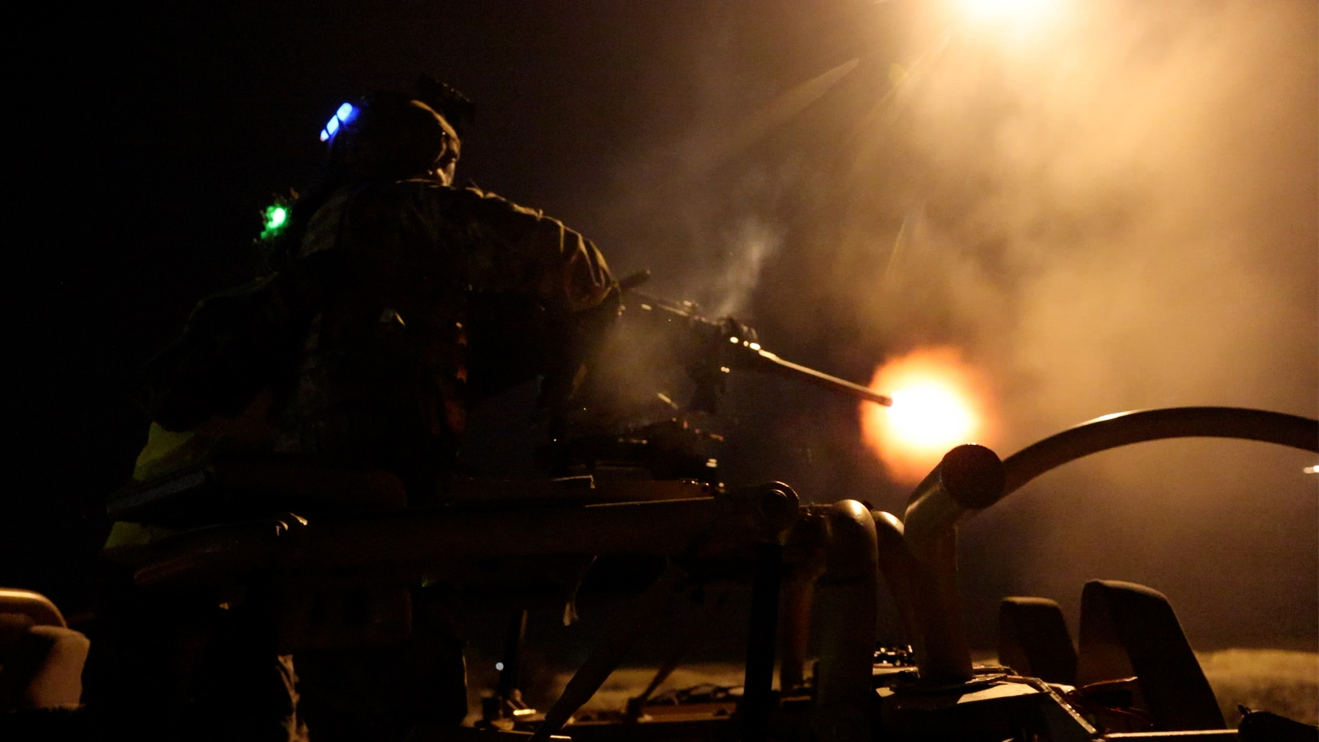 The muzzle flash from the HMG can't be avoided as this reservist engages targets up to 1,200 metres away