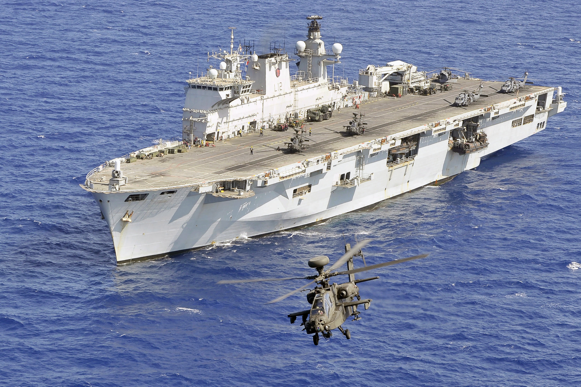An Army Air Corps Apache helicopter takes off from HMS Ocean during Operation Ellamy.