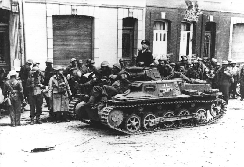 After the capture of Calais by fascist German troops, wounded British soldiers are brought out from the old town by German tanks