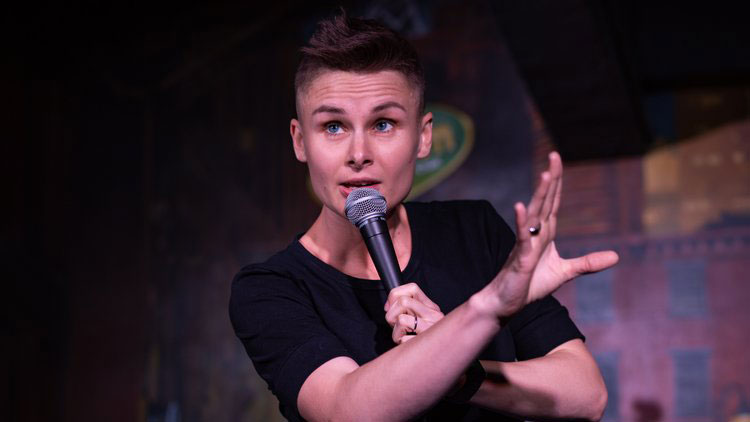 Comedian and military spouse Ashley Gutermuth on stage performing stand up CREDIT Photo Lady Photos