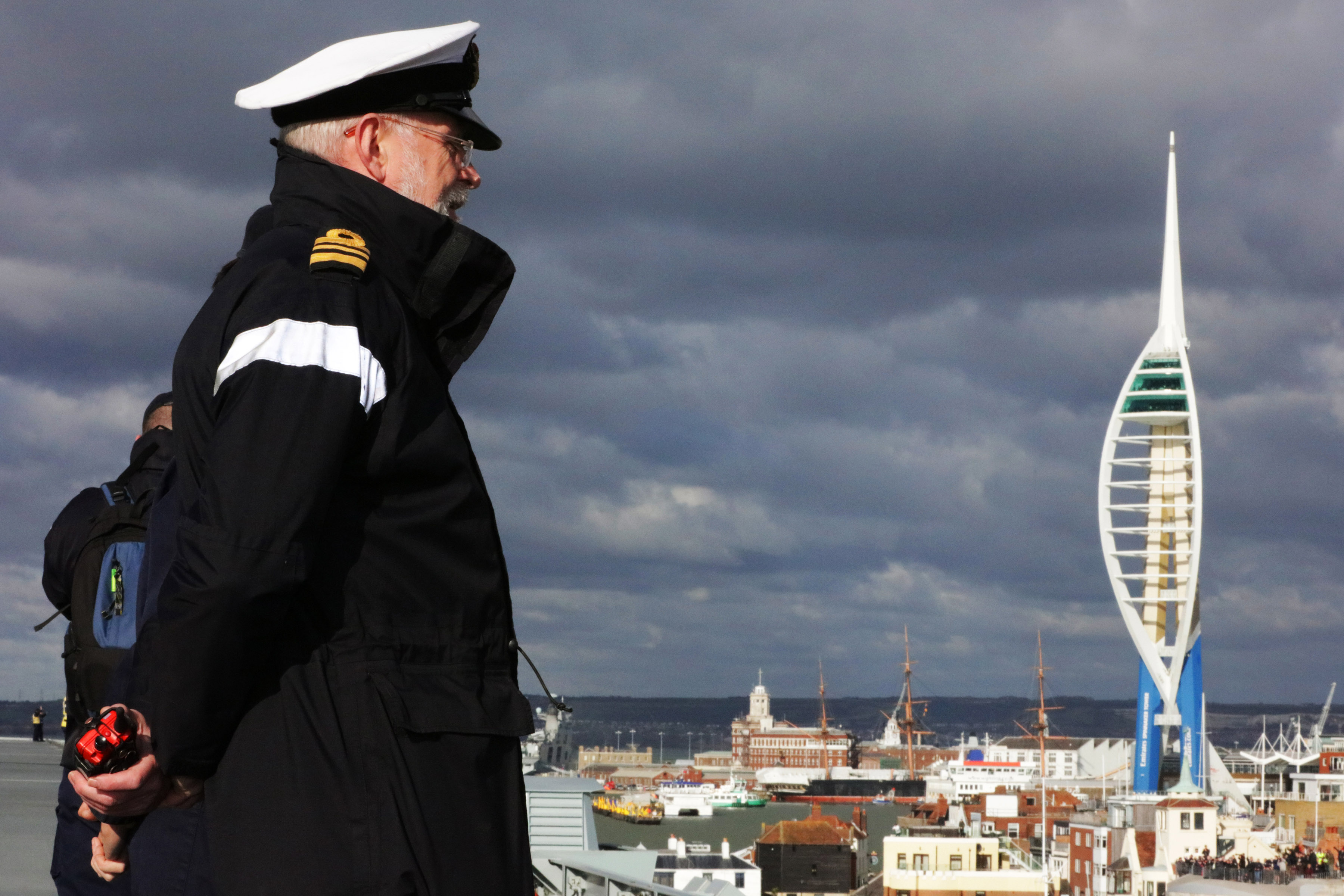 Lt Cdr Hawkins on the deck of HMS Queen Elizabeth entering Portsmouth
