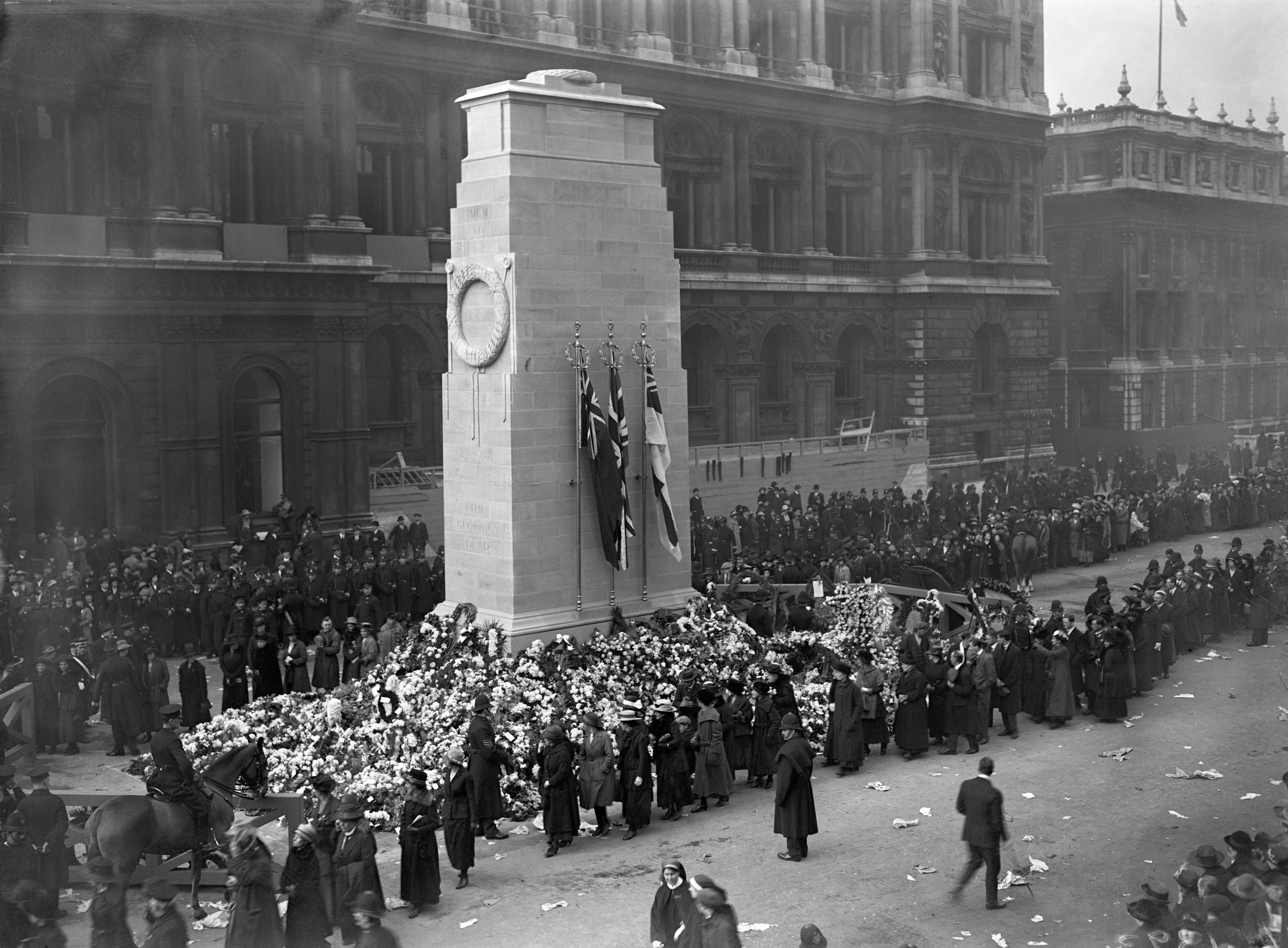 Members of the public filing past the wreath laden base of the Cenotaph on Armistice Day after its unveiling