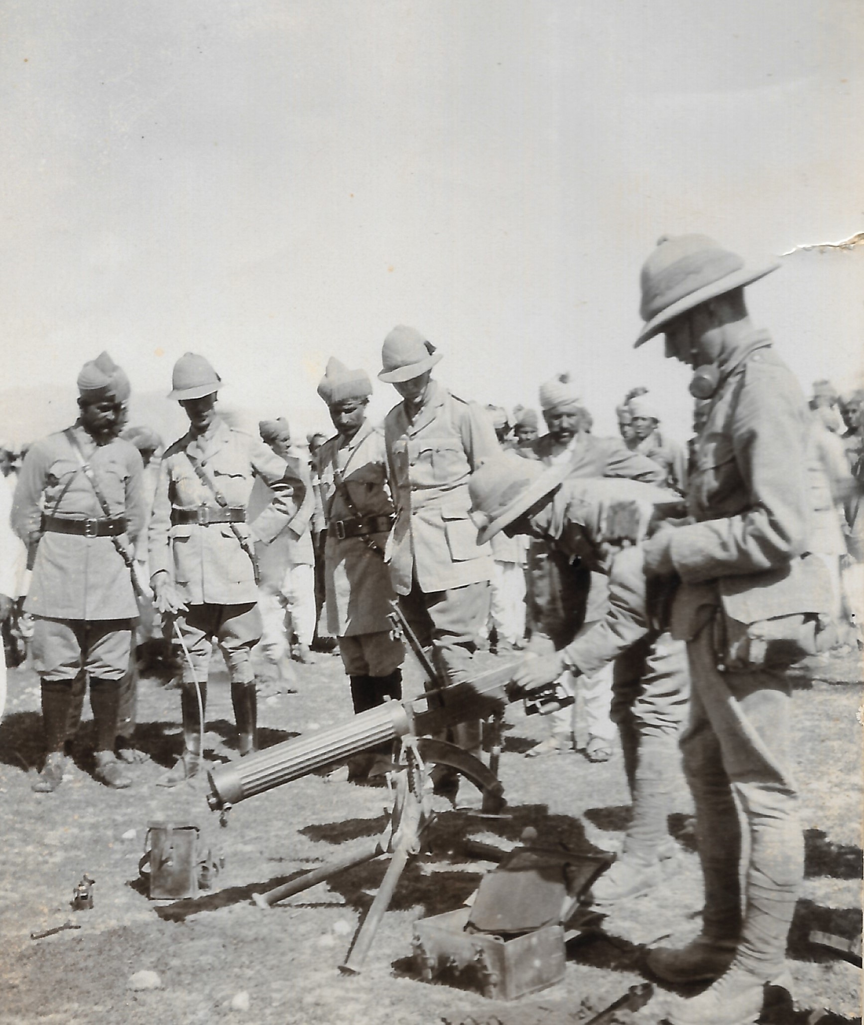 British soldiers inspecting and standing around a machine gun while on service in British India during or after World War 1