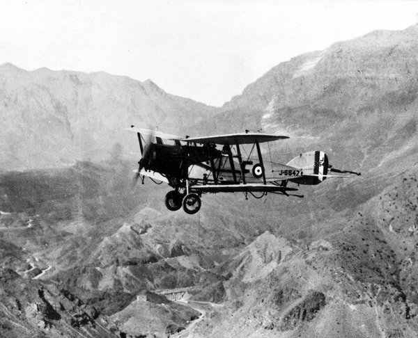 A Bristol Fighter biplane flying over the Khyber pass in the 1920s