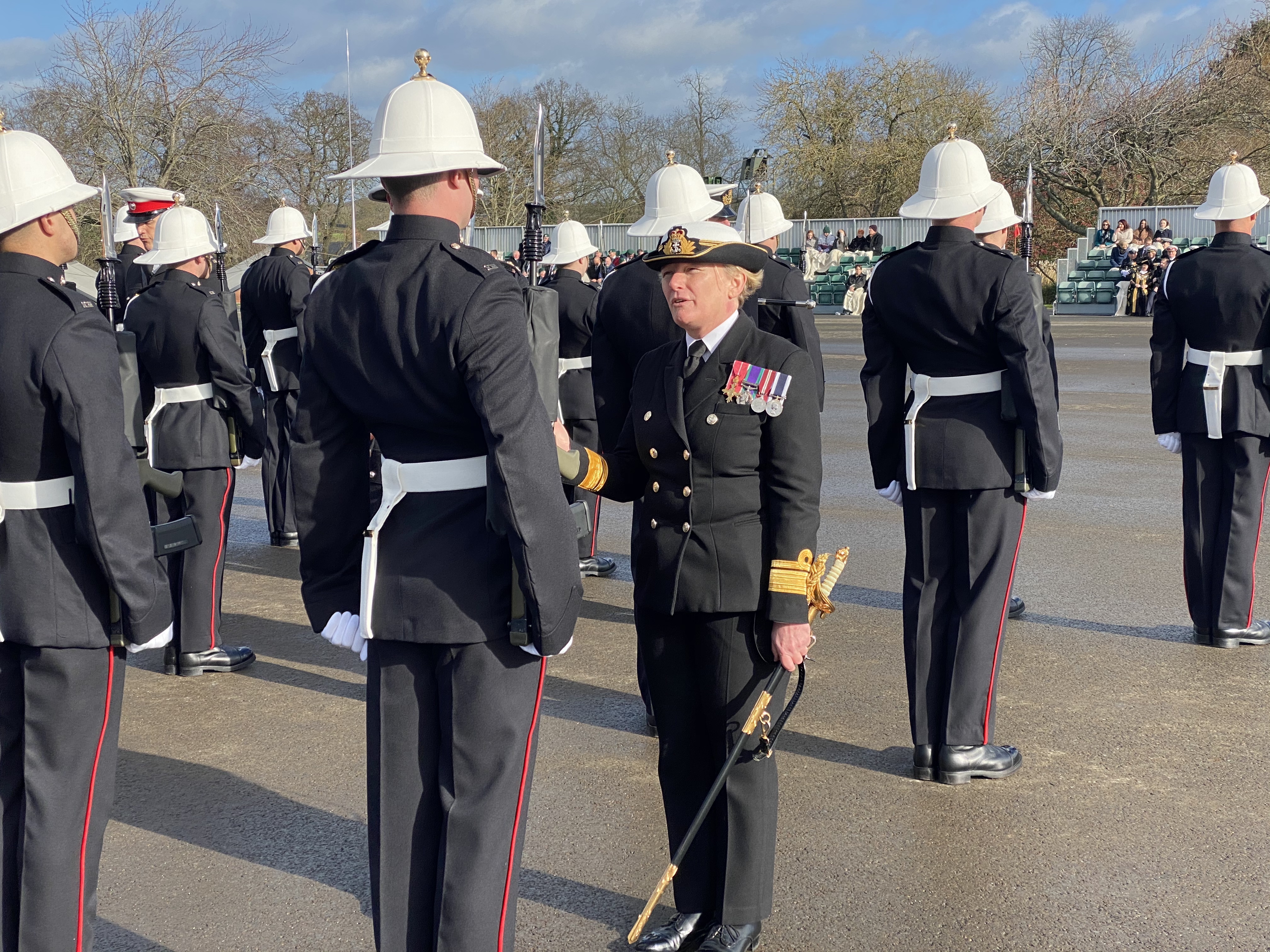 Rear Admiral Jude Terry OBE, the Royal Navy's first female Admiral, inspecting Royal Marines during a passing out parade at the Commando Training Centre, Devon
