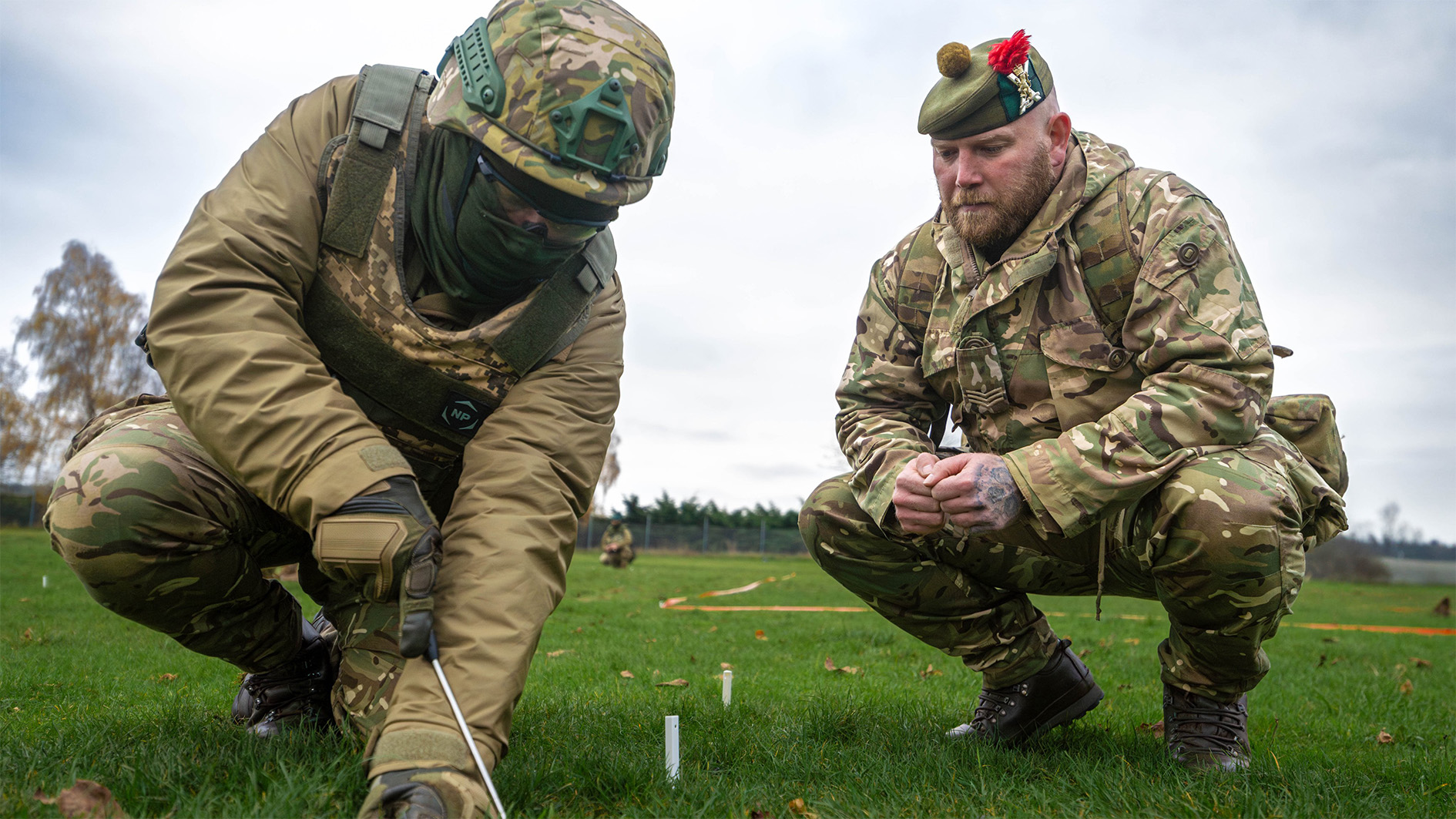 Ukrainian troop being shown how to detonate landmine