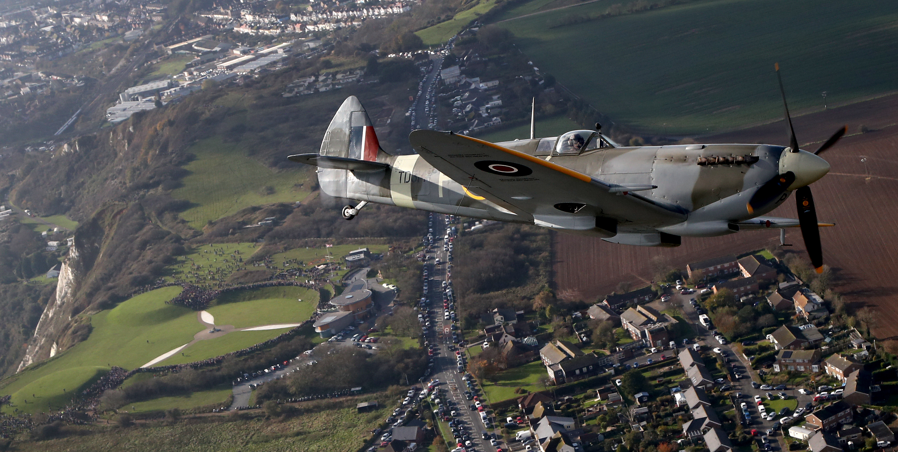 World War II Spitfire, flies over the Battle of Britain Memorial in Folkestone, Kent, in a tribute to the fallen on Remembrance Day 101119 CREDIT PA.jpg