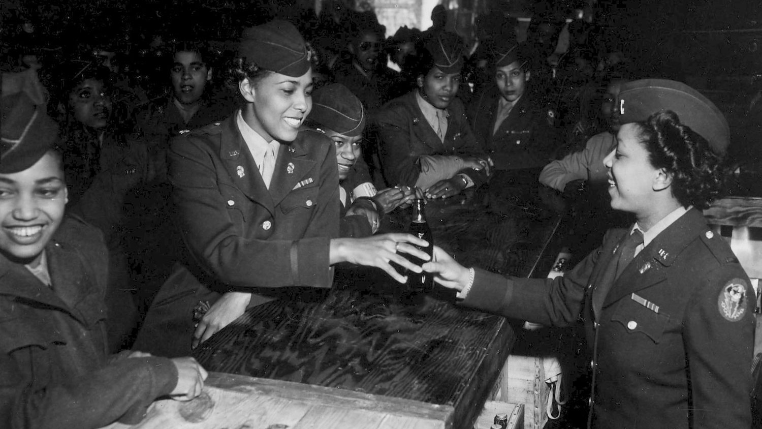 A 6888th Central Postal Directory Battalion member serves Major Charity Adams at the opening of the battalion's snack bar in Rouen, France 1 July 1945 CREDIT US Army