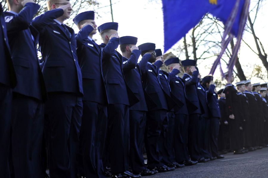 Airman Stands And Salutes National Anthems