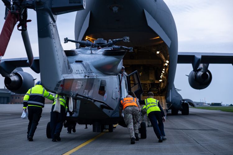 A Royal Navy Wildcat helicopter is loaded onto a RAF C-17 before it departs to bolster defences in Cyprus A Royal Navy Wildcat helicopter is loaded onto a RAF C-17 before it departs to bolster defences in Cyprus