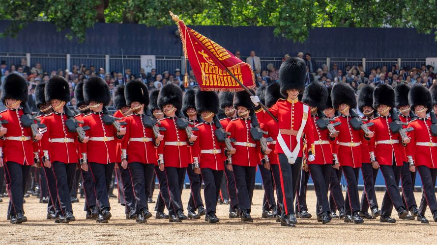 As the Guardsmen do an eyes right as they pass the podium from which the monarch is returning their salute, the Colour is flourished in front of the King As the Guardsmen do an eyes right as they pass the podium from which the monarch is returning their salute, the Colour is flourished in front of the King
