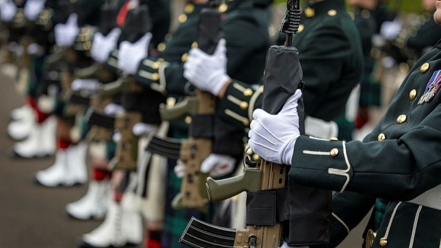 The soldiers present arms with their SA80 L85 A3 assault rifles - the role of the King's Guard is literally that - to protect the monarch The soldiers present arms with their SA80 L85 A3 assault rifles - the role of the King's Guard is literally that - to protect the monarch