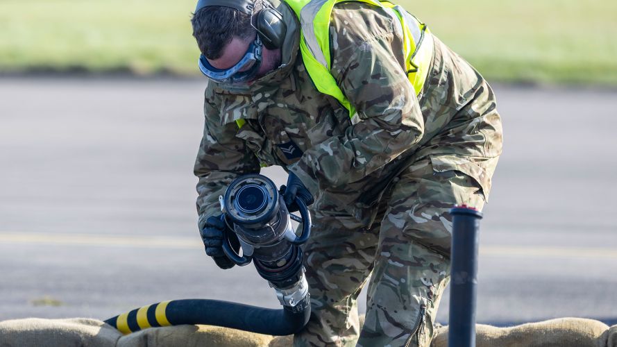 A member of the ground crew deployed to Leuchars Station from RAF Wittering prepares to attach a fuel line to a Typhoon as the jet keeps its engines running - process known as hot pit refuelling A member of the ground crew deployed to Leuchars Station from RAF Wittering prepares to attach a fuel line to a Typhoon as the jet keeps its engines running - process known as hot pit refuelling