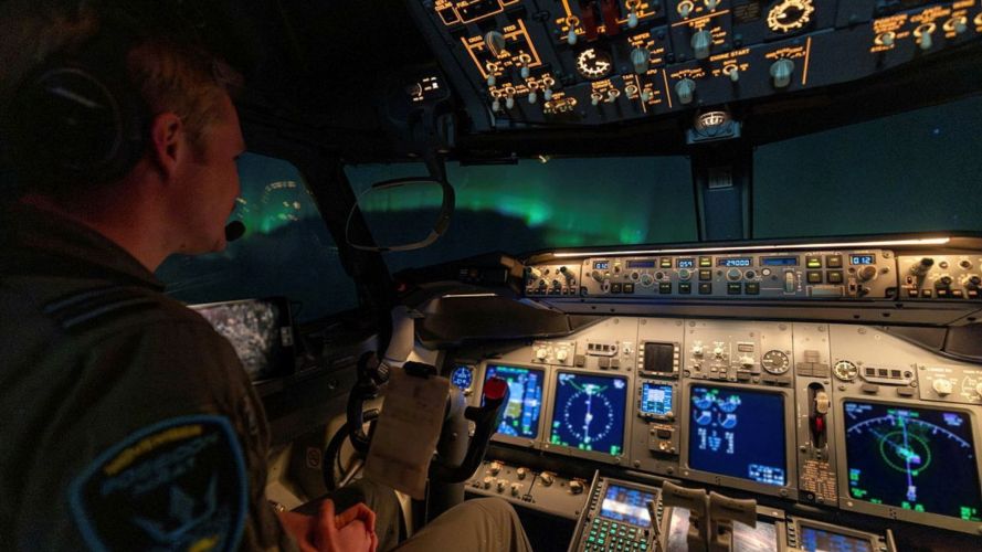 These crew members are being treated to a display of the Northern Lights as the aircraft descends into Keflavik Air Base These crew members are being treated to a display of the Northern Lights as the aircraft descends into Keflavik Air Base