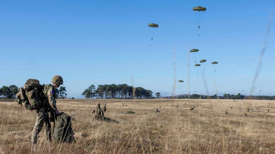 A soldier, with his bergen already on his back, packs away his parachute after landing on the drop zone at the St Cyr-Coëtquidan training area (Picture: MOD) A soldier, with his bergen already on his back, packs away his parachute after landing on the drop zone at the St Cyr-Coëtquidan training area (Picture: MOD)