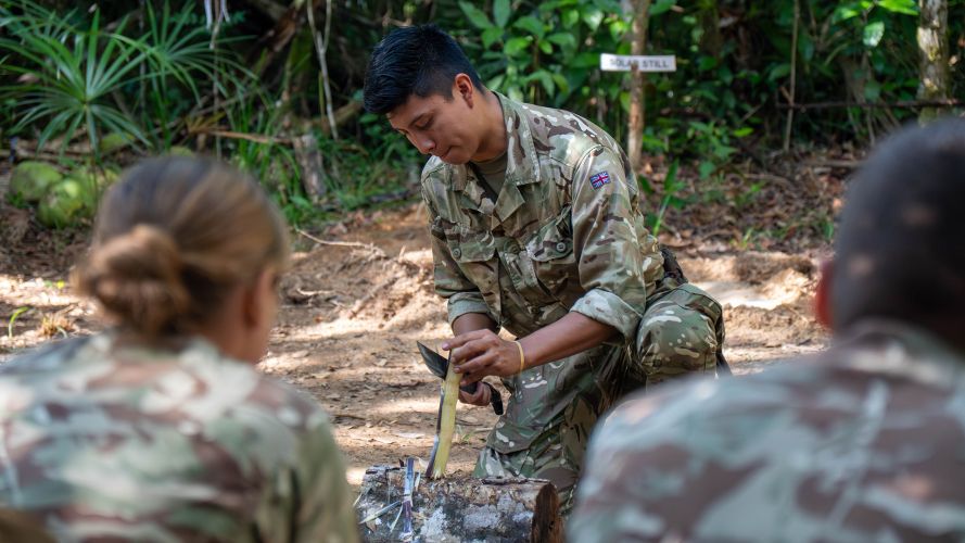 A member of personnel demonstrates how to make a fire in the jungle (Picture: Buckingham Palace) A member of personnel shows personnel how to make a fire in the jungle