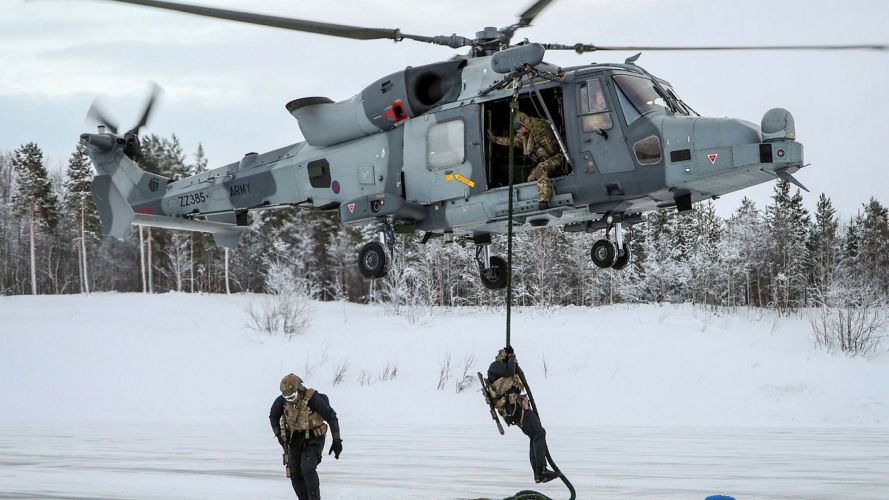 Personnel fast rope with their kit and rifle, replicating a real scenario (Picture: MOD) Personnel fast rope with their kit and rifle, replicating a real scenario