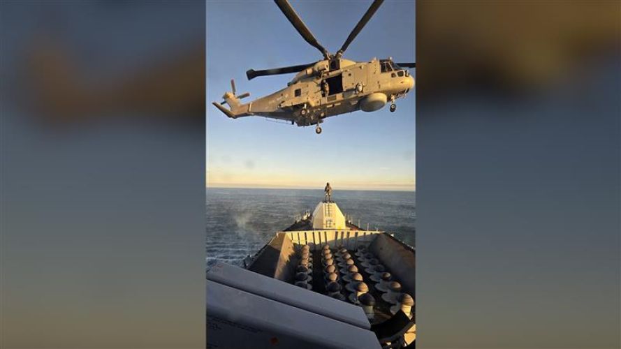 A Merlin helicopter hovers over HMS Somerset during her eight-month mission (Picture: Royal Navy) HMS Somerset returns home to Plymouth