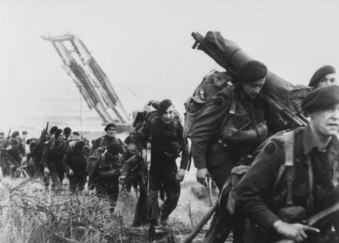 Royal Marine commandos move off a Normandy beach on D-Day (Picture: PA). Royal Marine commandos move off a Normandy beach on D-Day
