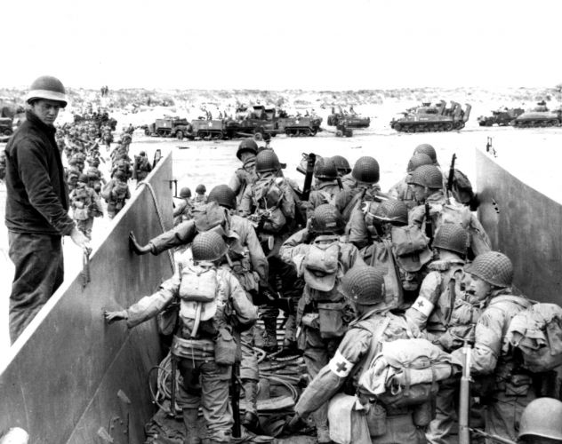 US Army troops disembark from a landing craft on a Normandy beach (Picture: PA). US Army troops disembark from a landing craft on a Normandy beach