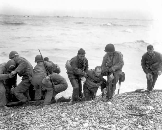 US personnel help injured soldiers ashore on Utah beach (Picture: LOC Photo/Alamy Stock Photo). US personnel help injured soldiers ashore on Utah beach
