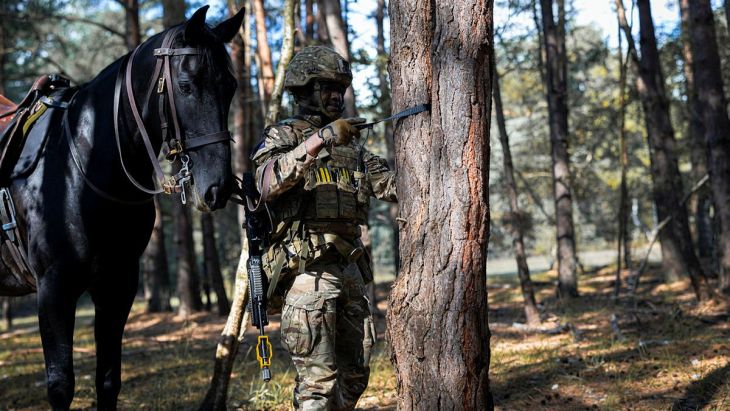 Soldier from HCMR bonding with his horse in a woodblock while taking a rest during mounted combat training ex