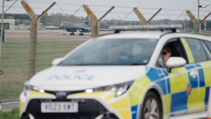 Police patrol the perimeter as a US Air Force Rockwell B-1 Lancer bomber lands at RAF Fairford in Gloucestershire (Picture: PA Images)