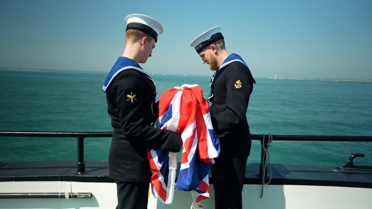 Leading Hand Kurt Tarrant and his fellow committals assistant carry out their duties committing ashes to the sea (Picture: BFBS)