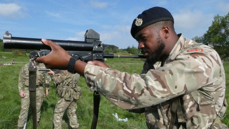Soldiers from the Royal Bermuda Regiment get hands-on with the L104 baton gun, which fires a plastic round (Picture: BFBS)