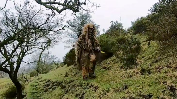 A trainee British Army sniper uses camouflage and concealment to keep the enemy - or in this case the Directing Staff - unaware of his presence