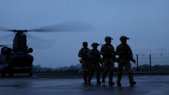 The rangers walk in front of a Chinook during Exercise Hyperion Storm