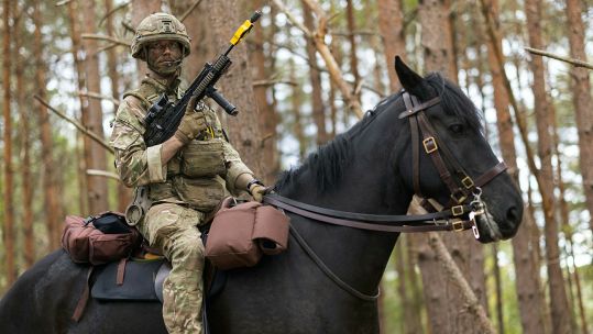 Lance Corporal of Horse Ben Chapman holds his SA80 L85A2 in the low port position during a mounted exercise on the Barossa Training Area at Sandhurst (Picture: MOD)