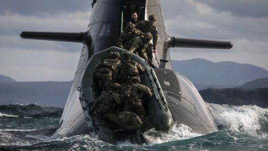 Soldiers from 148 (Meiktila) Commando Forward Observation Battery board a German submarine as they practise their float-on/float-off drills off the coast of Cape Wrath (Picture: MOD)
