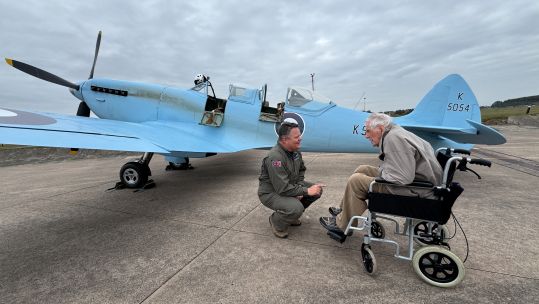 Former Spitfire pilot Douglas Seale chats with a pilot by a replica of the original protoype