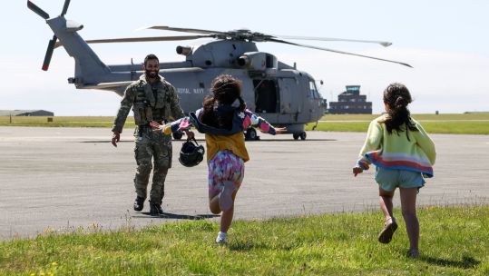 Children run to their father who has just returned from an air defence mission in Cyprus (Picture: MOD)