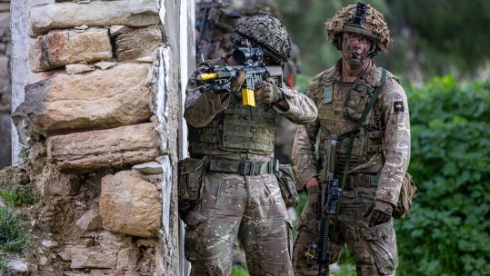 Two soldiers hide behind a wall on Exercise Kronos Warrior in Cyprus (Picture: MOD)