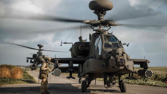 Army Air Corps AH-64E Apaches show off their versatility as they operate from a narrow track, with a support vehicle coming up from behind (Picture: MOD)