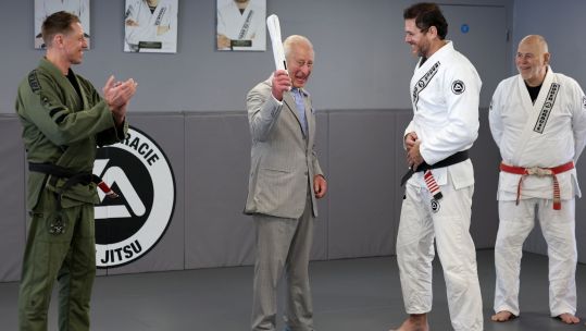 The King is awarded a white belt on his visit to the Roger Gracie Brazilian Jiu Jitsu (BJJ) Academy