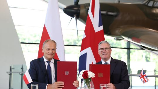 Poland's prime minister Donald Tusk and Sir Keir Starmer hold up the UK-Poland security agreement (Picture: Donald Tusk X)