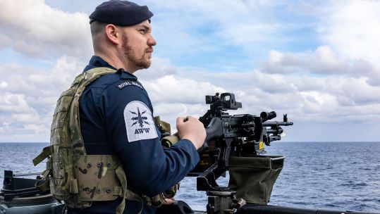 A GPMG gunner from the upper deck crew keeps a lookout as HMS Dragon heads to Cyprus to conduct air defence operations in the Eastern Mediterranean
