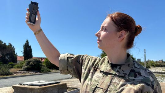 Senior Operational Meteorologist Flying Officer Robyn Waldie checks the weather conditions with an anemometer (Picture: BFBS)