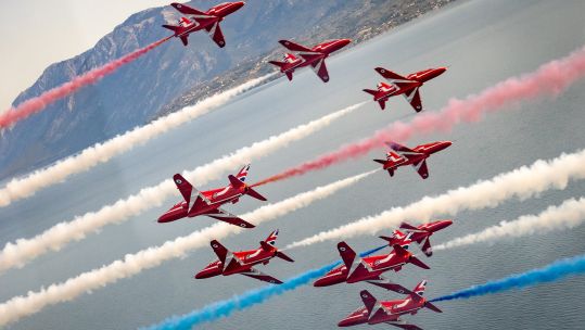 Red Arrows spraying their customary red, white and blue smoke from their Hawk T1 jets