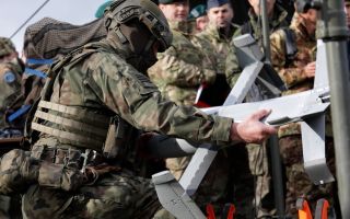A Polish soldier shows off the Surveyor - the drone-killing interceptor UAV that is the spear of the Merops system