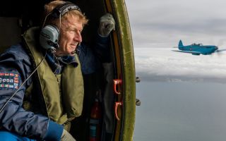 Former Army Air Corps officer and British astronaut Tim Peake looks on from the Battle of Britain Memorial Flight's Dakota