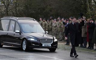 The cortege carrying the body of Lance Corporal George Hooley passes the Memorial Garden in Carterton, West Oxfordshire, following his repatriation into RAF Brize Norton