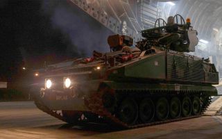 A Royal Artillery Stormer drives down the ramp of a C-17A Globemaster at RAF Akrotiri before taking up air defence duties in Cyprus